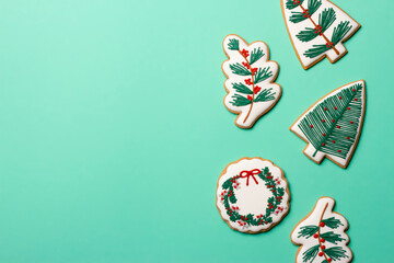 Christmas composition with decorations and cookies on a mint background