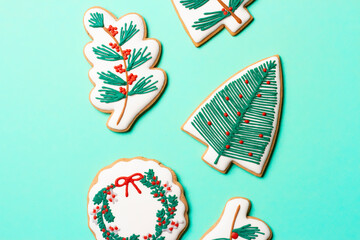 Christmas composition with decorations and cookies on a mint background
