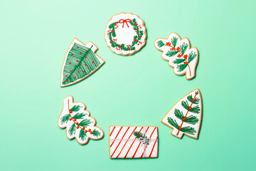 Christmas composition with decorations and cookies on a mint background