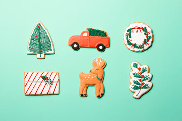 Christmas composition with decorations and cookies on a mint background