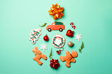 Christmas composition with decorations and cookies on a mint background