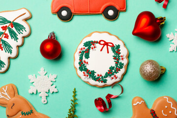 Christmas composition with decorations and cookies on a mint background
