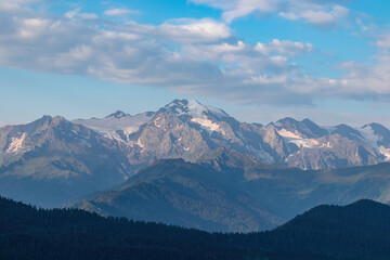 Naklejka premium An amazing view on the valley in Mestia in the Greater Caucasus Mountain Range, Upper Svaneti, Country of Georgia. Pink clouds cover the snow capped mountain peaks. Sunrise,Freedom,Outdoor,Trekking