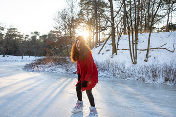 Excited woman ice-skating on frozen lake