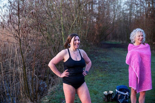 Smiling female friends standing in nature