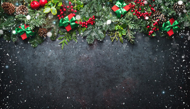 Christmas background with pine branches, berries, decorations and gift boxes