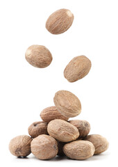 Nutmeg falls on a pile close-up on a white. Isolated