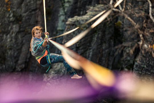 Young woman highlining in mountains at Baden-Baden, Germany