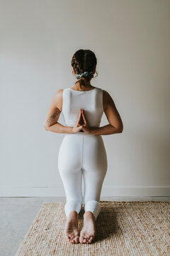 Flexible yogi practicing hands behind back yoga posture at health club