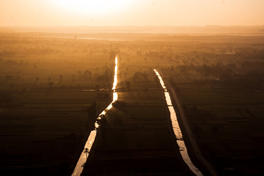 Sunrise over irregation chanels of the Nile River, in Luxor, Egypt.