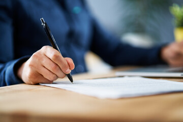 Businessman signing documents while working from home