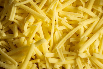 grated cheddar cheese background closeup