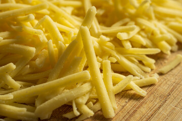 grated cheddar cheese background closeup