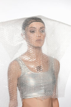 Cyborg Woman Covered With Bubble Wrap Plastic Against White Background