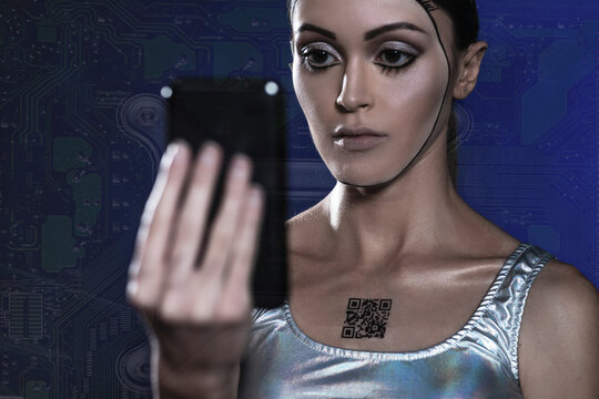 Robot woman with barcode on chest looking at smart phone