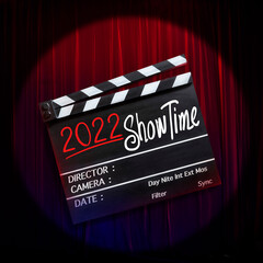 2022 show time, text title on movie Clapper board, and red theatre curtains background.