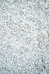light multi-color small stones and pebbles texture on the ground in the garden
