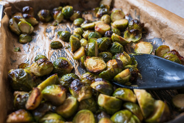 oven baked sliced brussels sprouts on baking tray closeup
