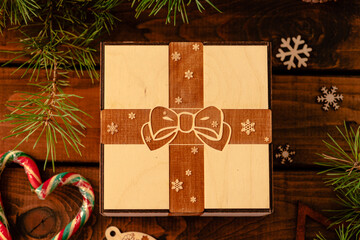 wooden box with an engraving of a bow and ribbon on the lid