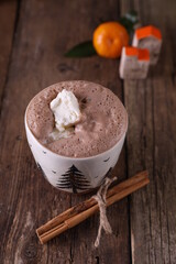 Cocoa with ice cream in a mug on a wooden background
