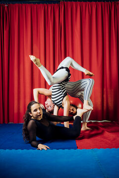 Female acrobats doing handstands while performing in circus