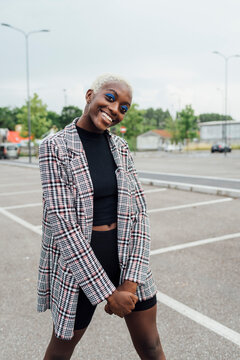 Smiling young woman standing on road