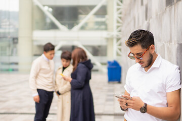 Young man with his female colleagues in the foreground.
