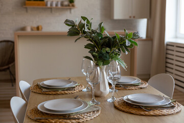 Breakfast setup on wooden table with nice vase and modern chair.
