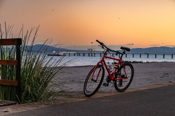 Parked red bike near the beach