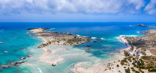 Tropical sandy beach with sandcastles and turquoise water, in Elafonisi, Crete, Greece