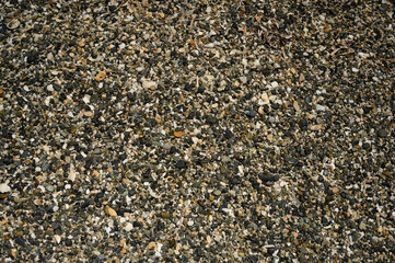 Small sea pebbles on beach. Colorful pattern rocks