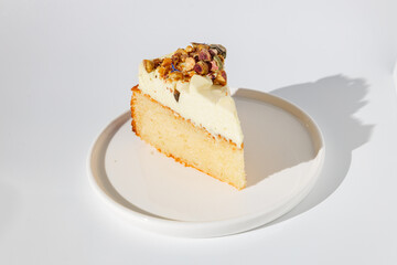 Piece of buttercream vanilla bisquit on white plate