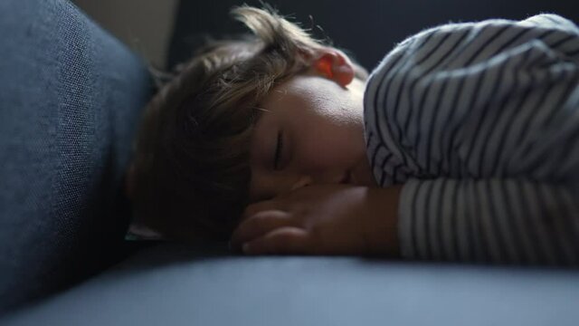 Little boy resting sleeping on sofa. child asleep