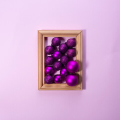 Christmas decorations in photo frame on pink background Christmas concept