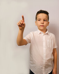 The boy shows an intelligent, attentive facial expression.