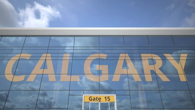 Commercial airplane reflecting in airport terminal with CALGARY text