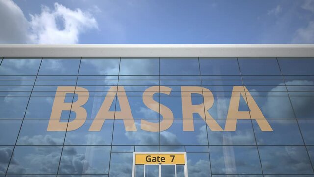 Plane reflects in the airport terminal with BASRA city name