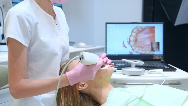 Dentist In Modern Clinic Using 3D Dental Intraoral Scanner For Scanning Teeth Patient's. Modern Dentistry And Healthcare Concept. Slow Motion Effect.