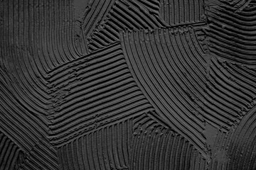 Embossed decorative plaster pattern with a pronounced black structure. Background. Texture.