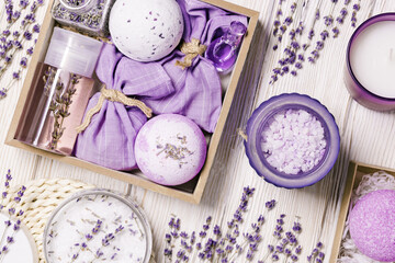 Products with lavender essential oil as handmade gift box, bath bombs, lavender spray and sachets on wooden table. Mindful gifting, natural aromatherapy cosmetics for body care
