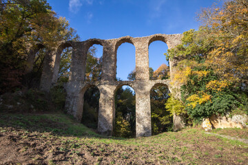 Fototapeta na wymiar Ruins of Roman Aqueduct located in Ancient Monterano,Canale Monterano,Italy.With the great beauty among natural environment surrounding,still good preserves the traces of the past.View from front