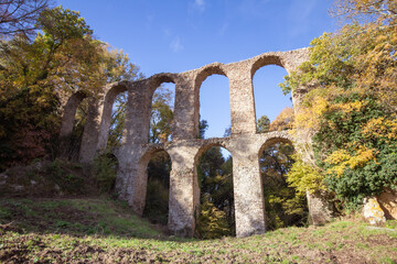 Fototapeta na wymiar Ruins of Roman Aqueduct located in Ancient Monterano,Canale Monterano,Italy.With the great beauty among natural environment surrounding,still good preserves the traces of the past.View from front