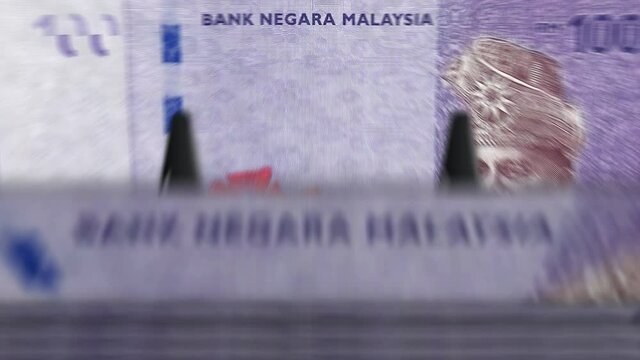 Malaysia Ringgit money counting machine with banknotes. Quick MYR currency note down rotation. Business and economy concept loopable and seamless background.
