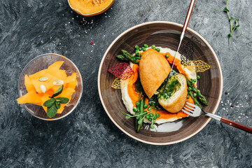 Breaded Chicken Kiev breast stuffed with butter, garlic and herbs served with asparagus and peas. banner, menu, recipe place for text, top view