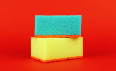 Yellow and blue sponges on a red background