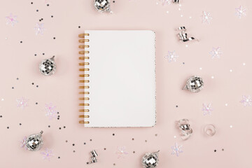 A blank notepad next to Christmas decor. New Year resolution, wish list, goals, diary, thoughts and dreams. Journaling concept.