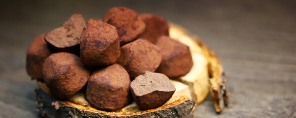 Selective focus. Macro. Chocolate truffles on a wooden surface.