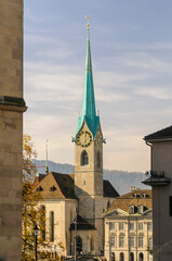 Zurich, Switzerland on October 20, 2012. Fraumunster Tower rising from behind buildings.