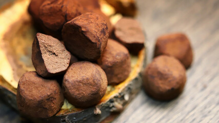 Selective focus. Macro. Chocolate truffles on a wooden surface.