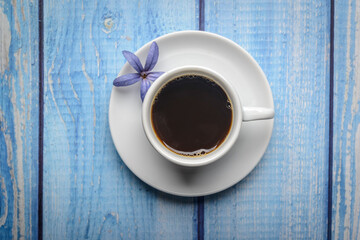 Coffee. White cup of coffee on a blue wooden table. Top view.